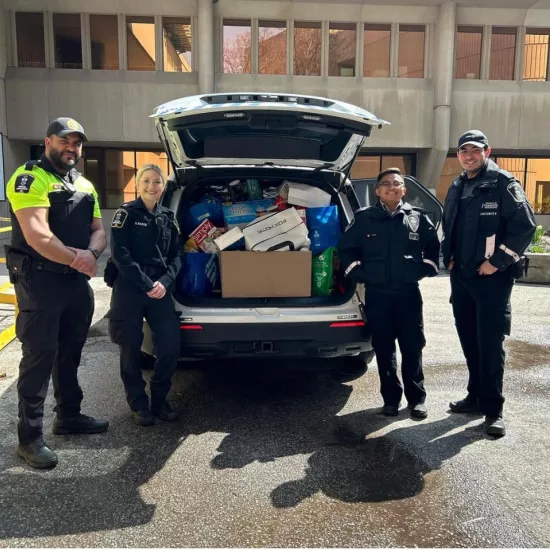 Campus Safety team with the cruiser filled with non-perishable food items.