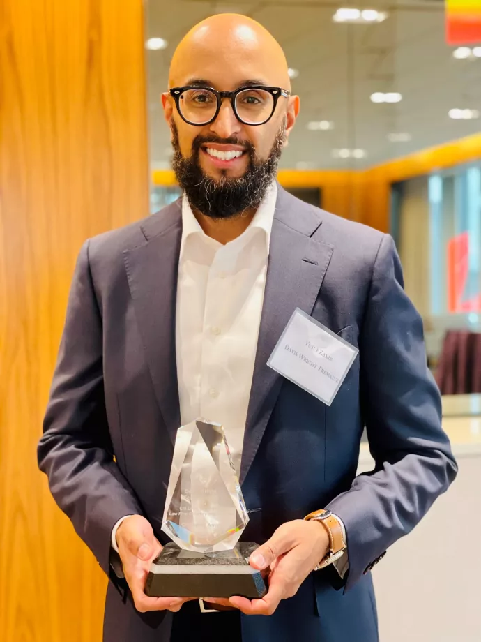 Yusuf Zakir holding the 2022 Citi Law Firm Diversity Champion Award, given to his firm, Davis Wright Tremaine, LLP.