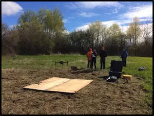 Ensminger lab launching a drone in a field