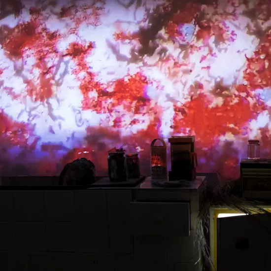 A red dappled pattern being projected on the way of a recreated kitchen
