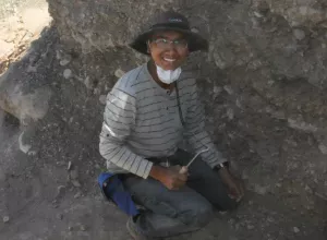 Jeremy Rimando excavates an earthen pit in Argentina