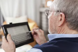 elderly man using a tablet