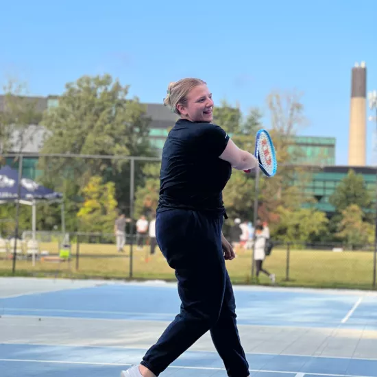 woman playing outdoor tennis