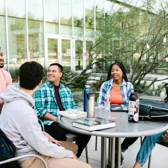 Students studying around a table outdoors