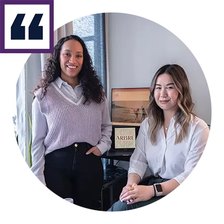 Two women pose for a portrait