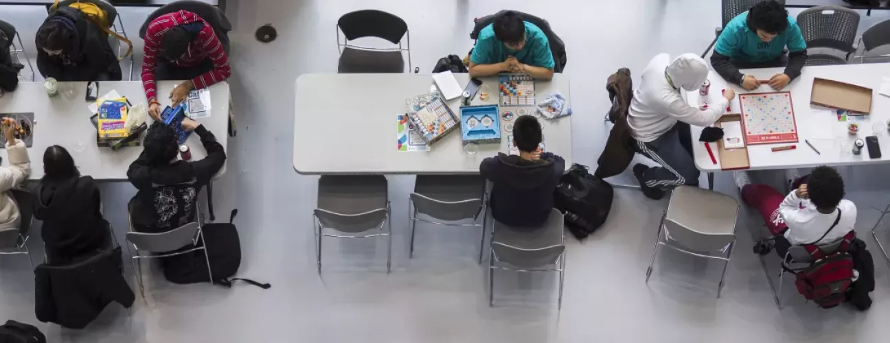 Students playing board games birds eye view