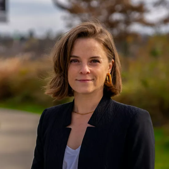 Headshot of Christine Cerullo with a background of tall grass and trees