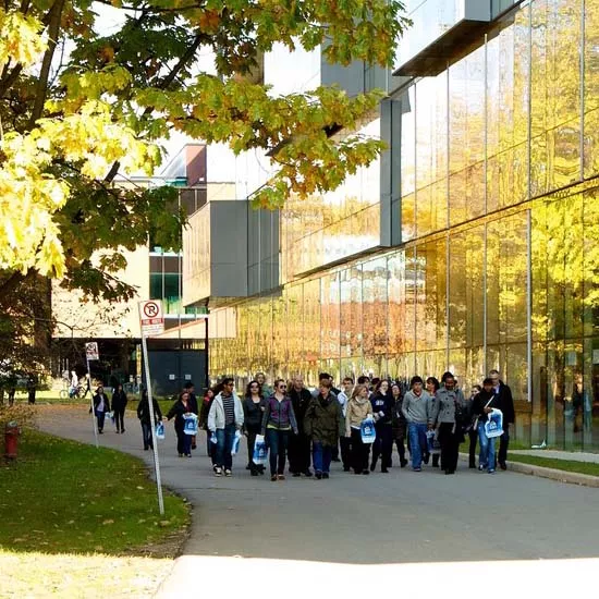 UTM Campus tour group walking in front of the CCT building
