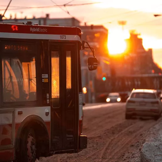 TTC bus turning on a downtown Toronto street at sunset. Photo by Brian Jones on Unsplash