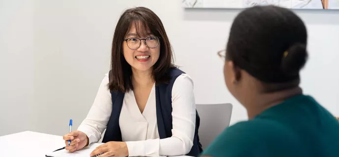 UTM staff talking in workspace