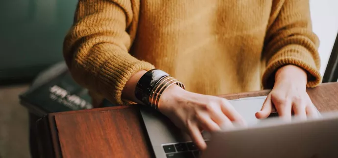 Hands typing on a laptop. Photo by Christin Hume on Unsplash