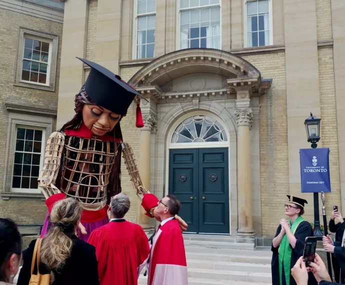 Little Amal with onlookers outside Convocation Hall