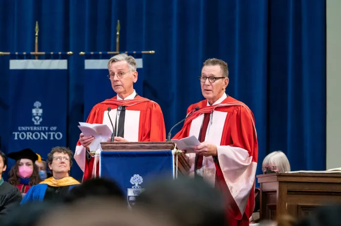 Adrian Kohler and Basil Jones at the podium inside Convocation Hall