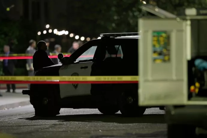 Police vehicle at crime scene with yellow crime scene tape in foreground