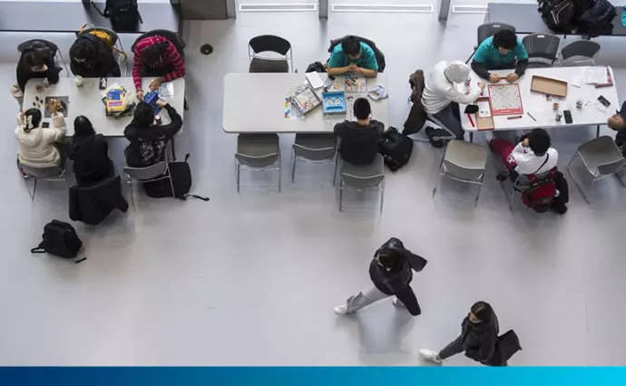 Students play board games in an atrium