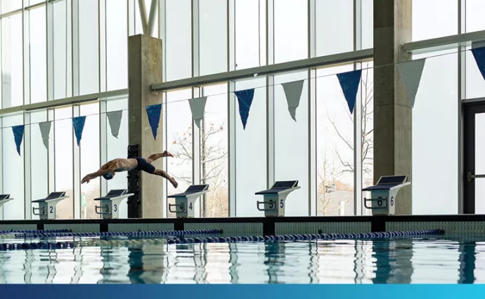 Swimmer diving into pool