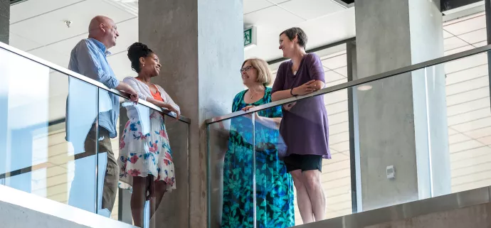 UTM staff talking in a hallway