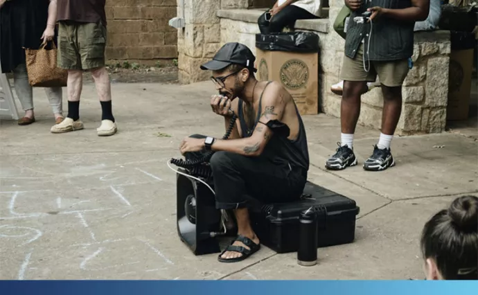 Man sits and speaks into acoustic device