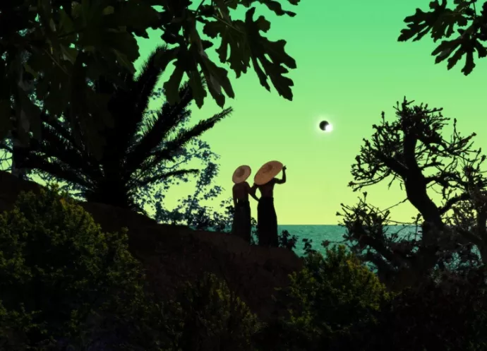 Two people standing on an overlook with vegetation, holding large brimmed hats on their head, watching an eclipse in the distance