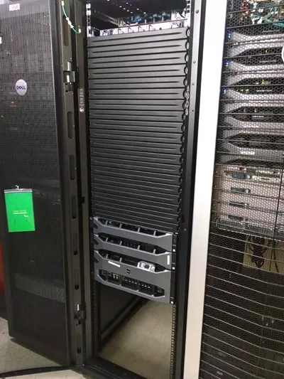 metal racks holding bank of servers making up computing cluster