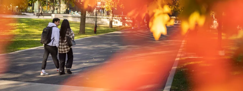 Two students walk on campus