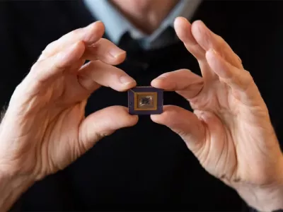 Hinton's hands holding an early Boltzmann chip