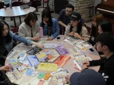 Students gathered around a board game