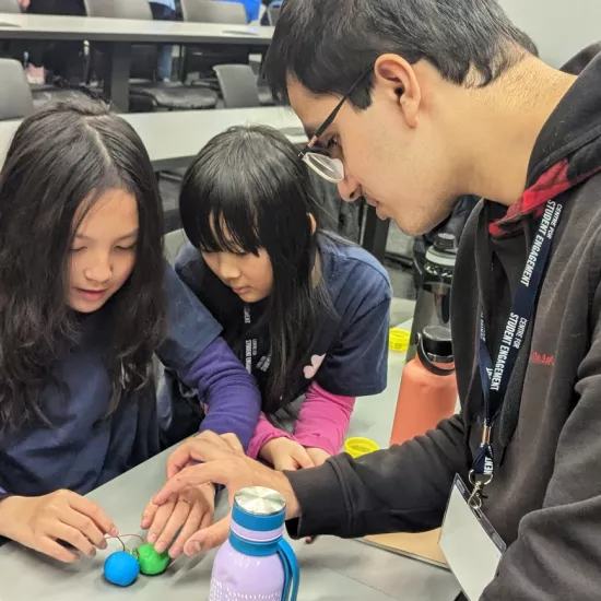 Participants in STEAM Mentorship Academy work on an experiment