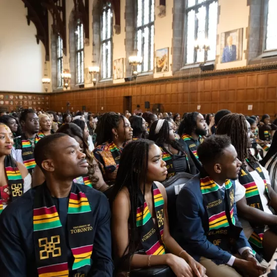 Graduating students and recent graduates from across the three campuses sit in Hart House’s Great Hall during the student-run Black Grad celebration