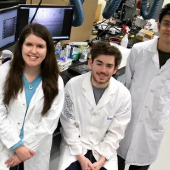 Three students in lab coats