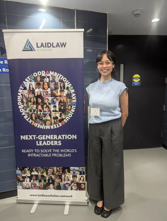 Hazel Antiporta stands beside a banner for the Laidlaw Scholars Programme