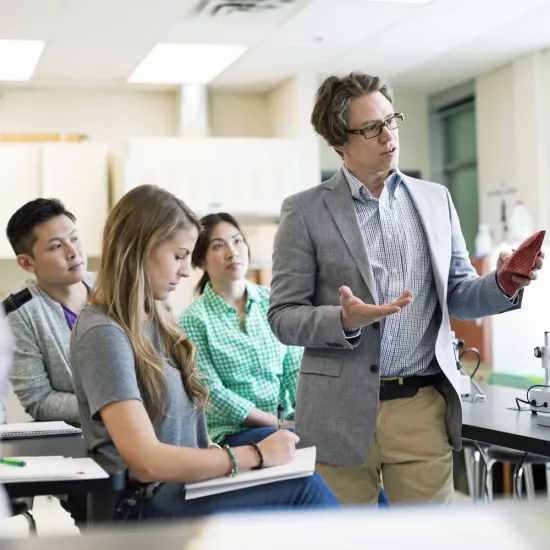 Professor teaching to students in room