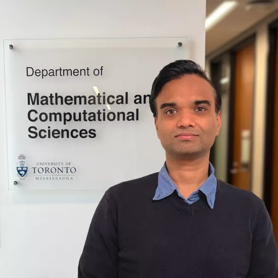 An image of Nishan Mudalige in front of the MCS Department sign.