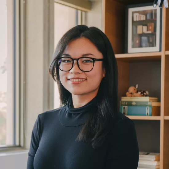 Sandra Ngan headshot in front of a bookshelf